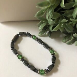 Magnetic hematite bracelet accented with green crystal beads.